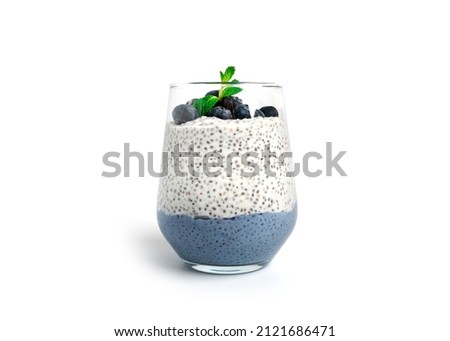 Chia pudding with blueberries isolated on white background. Chia pudding, mint and blueberries. High quality photo Royalty-Free Stock Photo #2121686471