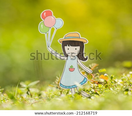 Young woman holding colorful balloons in the summer.