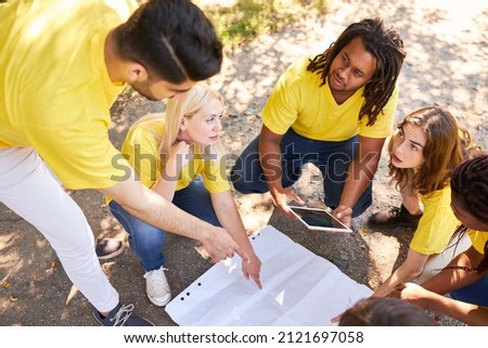 Young team on a treasure hunt while geocaching in the summer team building workshop Royalty-Free Stock Photo #2121697058