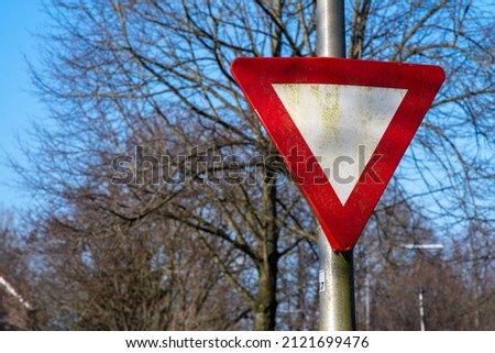 dutch priority sign, a white triangle with a red outline. Other drive goes first at the next crossing.