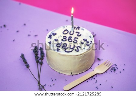 baby girl birthday cake on violet background