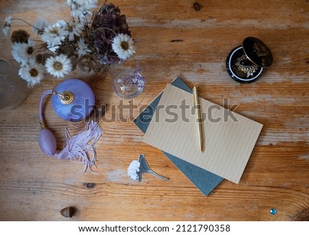 Old wooden table surface with cute girly items on it.  