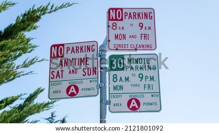 No parking signs in San Francisco, California. The three signs make it hard to understand for the visitors. No parking signs on a light pole