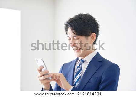 Asian businessman using the smartphone at the office