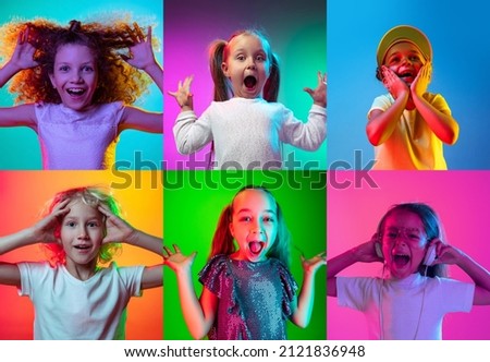Surprise. Children's emotions. Set of portraits of little cute kids, boys and girls isolated on multicolored background in neon light. Education, wow emotions, facial expression and childhood concept. Royalty-Free Stock Photo #2121836948