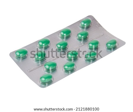 Green vitamin medcine pills in blister isolated on the white background