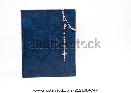 Rosary on the Bible, dark color, cross, religion, prayer. isolated