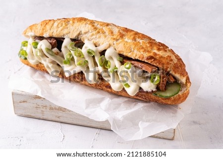 Baguette Asian fusion vegan sandwich with fermented and fresh vegetables on textured white Royalty-Free Stock Photo #2121885104