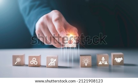 Hand arranging wood block stacking with business strategy and Action plan,targeting the business concept.business development concept. Royalty-Free Stock Photo #2121908123