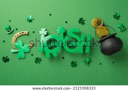 Top view photo of the green extravagant glasses in shape of word irish little black pot with coins bronze horseshoe and confetti in shape of clovers and hats on the green background