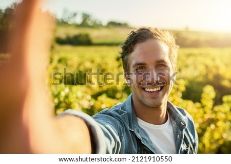 Time to get my harvest on. Shot of a young man taking a selfie while working on a farm.
