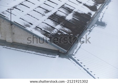 slate roof covered with snow in winter