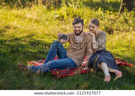 young couple taking a selfie in nature