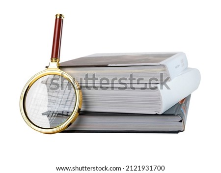 Books stack and magnifying glass isolated on white background. Education, relevant information search, reading concept. High quality photo