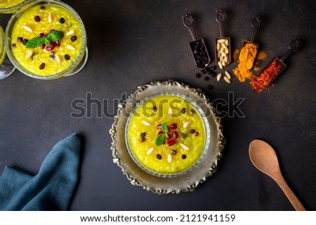 The traditional dessert of the Ottoman palace,Pudding-like sweet; Turkish Traditional Dessert Zerde Royalty-Free Stock Photo #2121941159