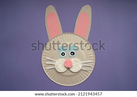 Easter card handmade. Step by step photo instruction. Children's art project. DIY concept. Very Peri background color 2022. Top view, Flat lay. Step 4. Rabbit is ready.