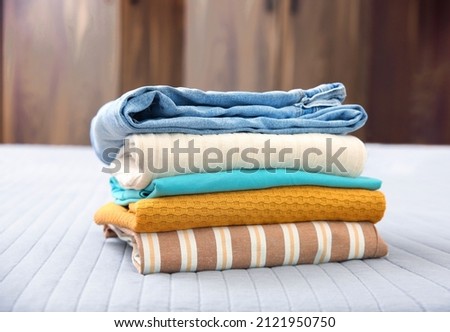 Stack of clothes. Pile of cotton garment.Folded clothing closeup. Laundry. Royalty-Free Stock Photo #2121950750