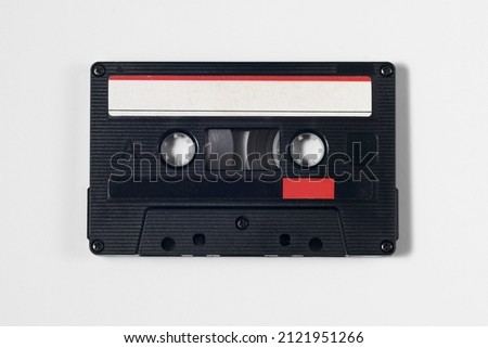 Vintage audio cassette isolated white background. red and white label. Use marks.