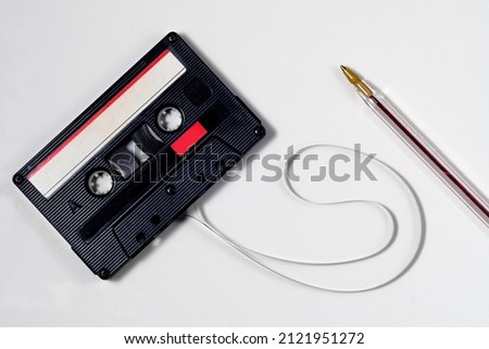 Vintage audio cassette isolated white background. red and white label. Use marks.Tape. Bic pen