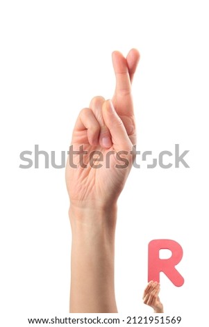 Alphabet - letter R spelling by woman's hand in American Sign Language (ASL) on white background