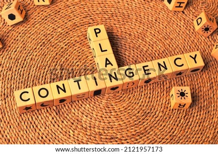 CONTINGENCY PLAN word text from wooden cube block letters on braided rattan mats background. Contingency plan is a plan devised for an outcome other than in the usual or expected plan. Royalty-Free Stock Photo #2121957173