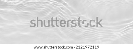 Water texture with sun reflections on the water overlay effect for photo or mockup. Organic light gray drop shadow caustic effect with wave refraction of light. Long banner with empty space. Royalty-Free Stock Photo #2121972119