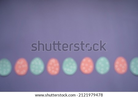Blurred image to implement design ideas. Easter background with eggs, option 3. Copy space. Vertical orientation. Flat lay, top view. Very Peri background color 2022.