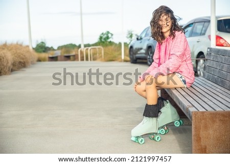 portrait of young child or teen girl roller skating outdoors, firness, wellbeing, active healthy lifestyle. High quality photo