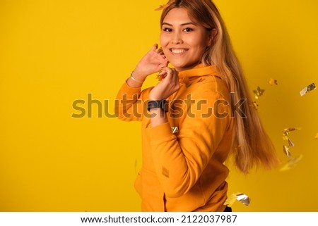 A woman in yellow clothes rejoices in a holiday