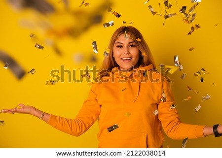 A woman in yellow clothes rejoices in a holiday