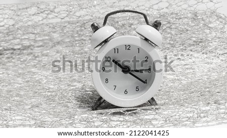 clock with an old model, can ring loudly as your sleep alarm, photographed in monochrome
