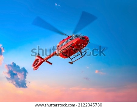 Red color helicopter in the air. Great photo on the theme of air medical service, air transportation,  air ambulance,  fast city transportation or helicopter tours.  Royalty-Free Stock Photo #2122045730