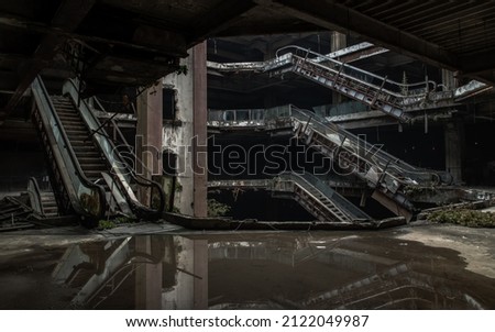 Damaged escalators and waterlogged in abandoned shopping mall building. Structural and ruins was left to deteriorate over time, New World Mall, No focus, specifically. Royalty-Free Stock Photo #2122049987