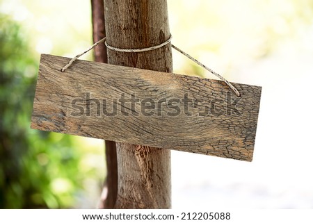 Wooden signboard is hanging on the tree