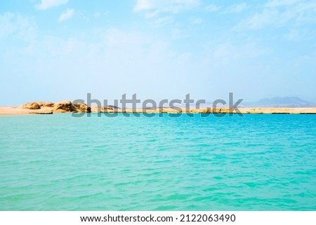 Beautiful sea views of different colors, waves, sandy coast, Egypt Red Sea, mountains. Blue green turquoise sea water