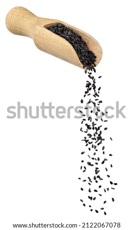 black sesame seeds falling from wooden spoon isolated on white background Royalty-Free Stock Photo #2122067078