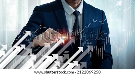 A businessman shows an arrow graph that depicts the company's future growth strategy and percentage increase. The idea is to start a business from the ground up in order to succeed and grow. Royalty-Free Stock Photo #2122069250