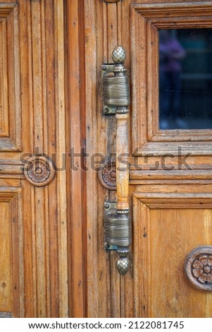 Antique wooden door with beautiful door handle.