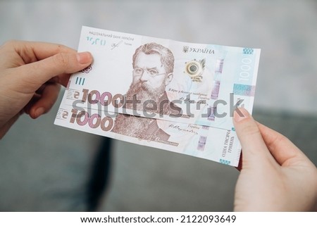 Hand holds two banknotes of 1000 hryvnia. Ukrainian hryvnia. Currency of Ukraine