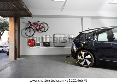 Particular Electric Vehicle Charging Station at home. Royalty-Free Stock Photo #2122146578
