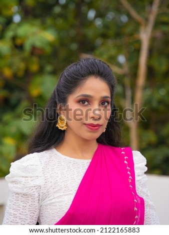 Portrait of Beautiful Indian Girl in Pink Saree and White Crop Top