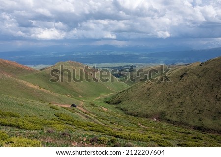 Off-road vehicle on dangerous off-road mountain trail background. Offroad journey, travel. Summer travel concept. Mountain road. Trip concept. Kyzyl-auz mountain pass. 