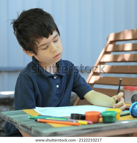 Child boy have a leisure by drawing, outdoor