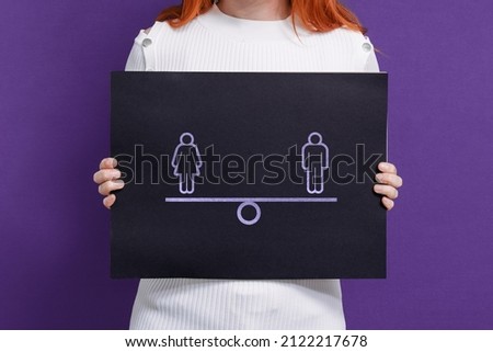 Girl with feminist poster on gender equality on a purple background