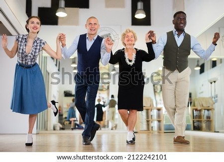 Group of different age dancers preparing swing