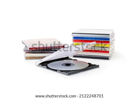 CD in an open box on the background of a stack of disks on a white background
