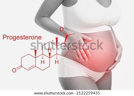 Pregnant woman and progesterone hormone formula on white background Royalty-Free Stock Photo #2122259435