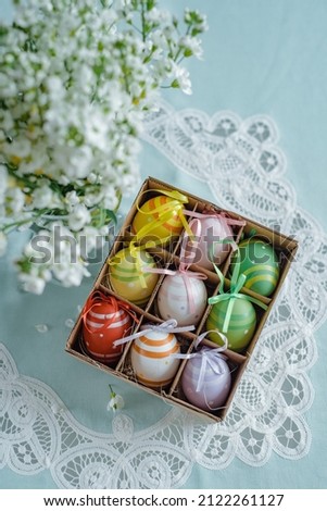 Colorful Easter eggs background. Close up colorful easter eggs in a basket and spring flowers.