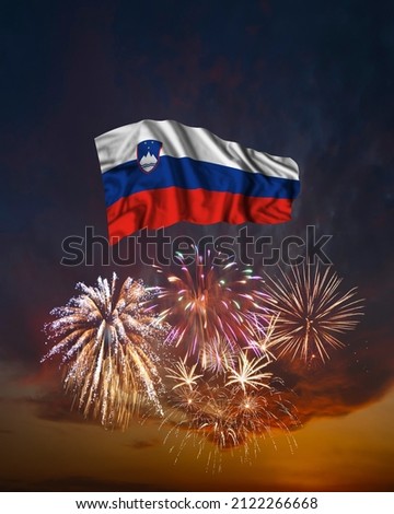 Holiday fireworks in evening sky and flag of Slovenia for National Independence day