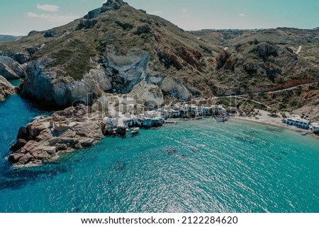 Drone aerial view of rock formations and cliffs surrounded by turquoise waters of Aegean Sea in the beach in Milos Island Greece